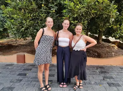 a group of three women standing next to each other at Back Packers Cochin Villa in Cochin