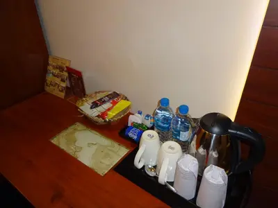 a counter with bottles of water and a tea kettle at Paramount Tower in Kozhikode