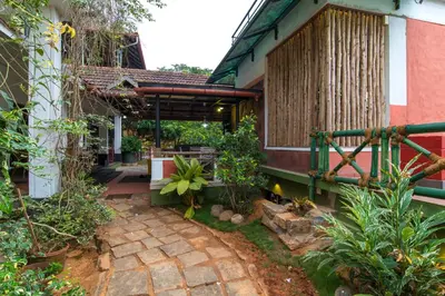 a courtyard of a house with a patio at Olives The Boutique Resort in Kalpetta