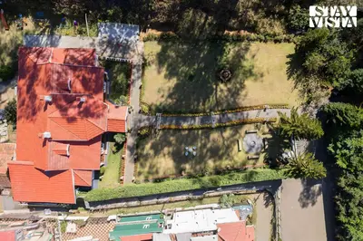 an aerial view of a house with a yard at Greenwood Bungalow Heritage In the heart of Ooty in Ooty