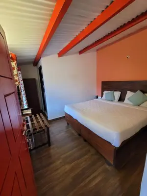 a bedroom with a large bed in a room at REFLECTIONS Guest House in Ooty