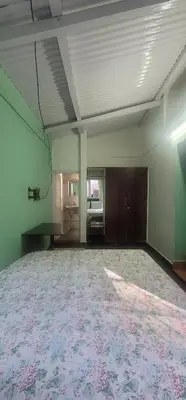 an empty room with a large room with a table at REFLECTIONS Guest House in Ooty