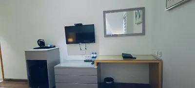 a room with a desk with a computer and a monitor at The Mayberry -A Bergamont Group of Hotels in Tiruppūr