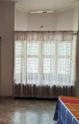 a room with a large window with white curtains at Maleyam Homestay Riverside in Kozhikode