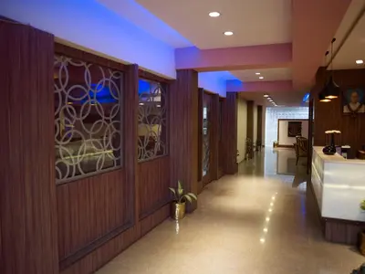 a hallway with wood paneled walls and a hallway with a sink at Comfort Hotels in Coimbatore