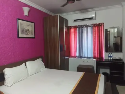 a bedroom with a bed and a purple wall at French Avenue in Kallāyi