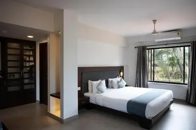 a bedroom with a large bed and a window at Copper Folia in Kozhikode
