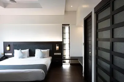 a bedroom with a large white bed in a room at Copper Folia in Kozhikode