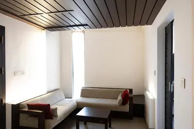 a living room with a couch and a chair at Copper Folia in Kozhikode