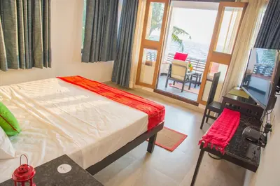 a bedroom with a bed and a view of the ocean at 36 Palms Residency - Sea View Villa in Cochin