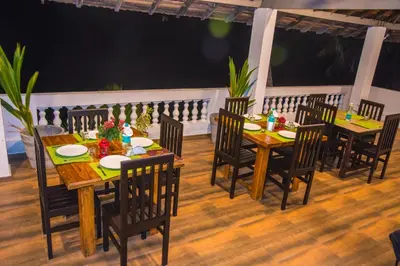 a group of tables and chairs on a patio at 36 Palms Residency - Sea View Villa in Cochin