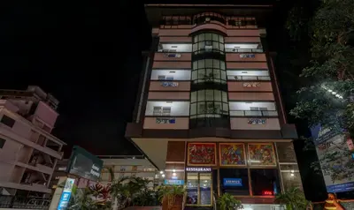 a tall building at night with lights on at Itsy Hotels Ammu Regency in Trichūr