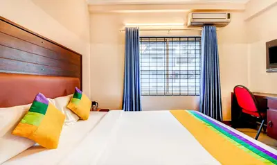a bedroom with a bed and a window at Itsy Hotels Ammu Regency in Trichūr