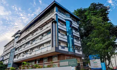 a tall building with blue trim on top of it at Itsy Hotels Ammu Regency in Trichūr
