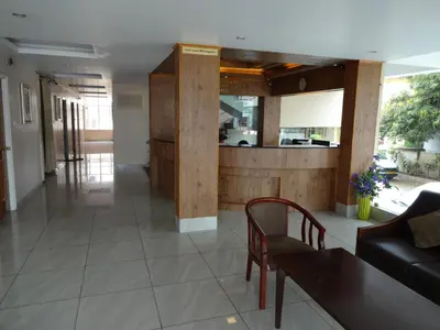 a living room with a couch and a table at Hotel Sky Lite in Coimbatore
