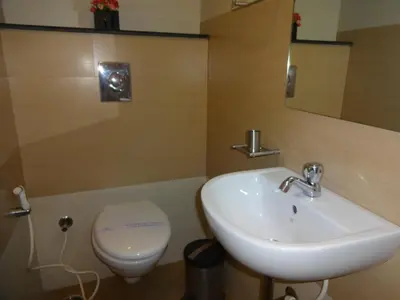 a bathroom with a sink and a toilet at Hotel Sky Lite in Coimbatore