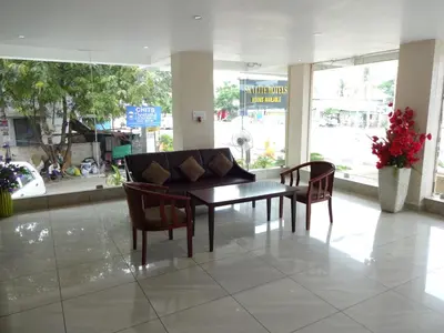 a living room with a couch and two chairs at Hotel Sky Lite in Coimbatore