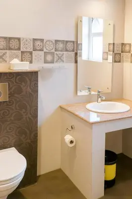 a bathroom with a sink and a toilet at The Majestic Crown in Ooty