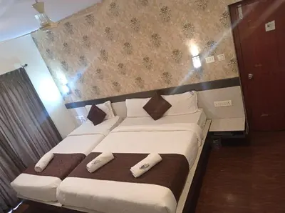 a bedroom with a large bed with two pillows at The Majestic Crown in Ooty