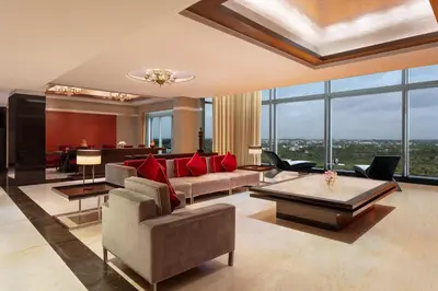a living room with a couch and a table at Le Meridien Coimbatore in Coimbatore