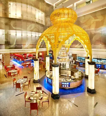 a restaurant with a large gold gazebo in a building at Le Meridien Coimbatore in Coimbatore