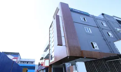 a tall building with a wooden facade on a street at Itsy Hotels Jansi Residency in Coimbatore