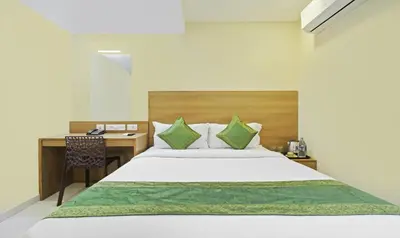 a bedroom with a bed and a desk at Itsy Hotels Jansi Residency in Coimbatore