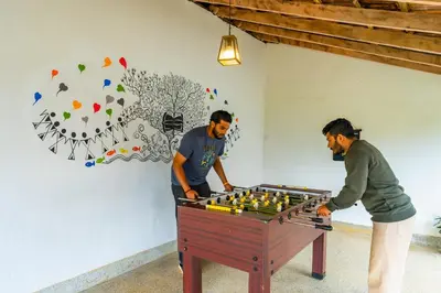 two men playing a game of chess on a table at Zostel Plus Wayanad in Kalpetta