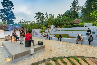 a group of people sitting on a bench in a park at Zostel Plus Wayanad in Kalpetta