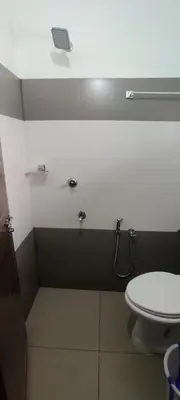 a bathroom with a white toilet and a sink at Apsara Residency in Perintalmanna