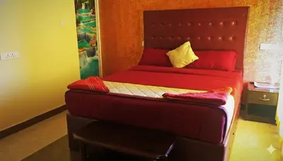 a bed with red sheets and yellow pillows in a room at The Bowers Chalet Private Campfire & Lawn BBQ, WIFI, Breakfast Hill Top 360 degree view in Ooty