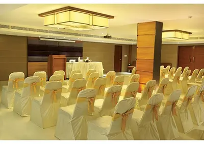 a room with rows of chairs and a table in a room at Jk Park Residency Perambra in Mennānyam
