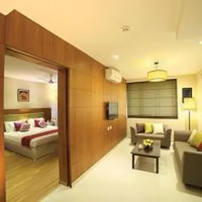 a living room with a bed and a couch at Jk Park Residency Perambra in Mennānyam