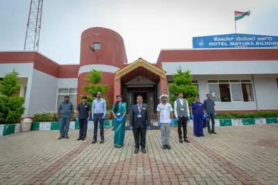 a group of people standing in front of a building at KSTDC Hotel Mayura Biligiri, BR Hills in Honganūr