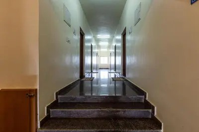 a hallway with stairs in a building at KSTDC Hotel Mayura Biligiri, BR Hills in Honganūr