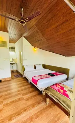 a bed in a room with a ceiling at Coorg Heritage Hill View By The Avyaan in Madikeri