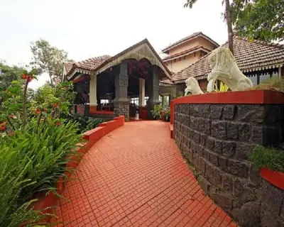 a red brick walkway in front of a house at The Porcupine Castle Resort in Madikeri