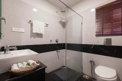 a bathroom with a sink and a toilet and a shower at StayVista at Aashirwaad Villa in Coonoor