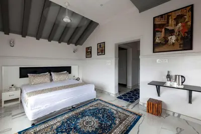 a bedroom with a large bed and a rug at StayVista at Aashirwaad Villa in Coonoor