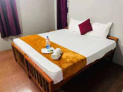 a bed with a bottle of water on top of it at GoNest O Zen in Kozhikode