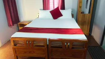 a bedroom with a large bed with a red curtain at GoNest O Zen in Kozhikode