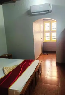 a bedroom with a bed and a window in a room at GoNest O Zen in Kozhikode