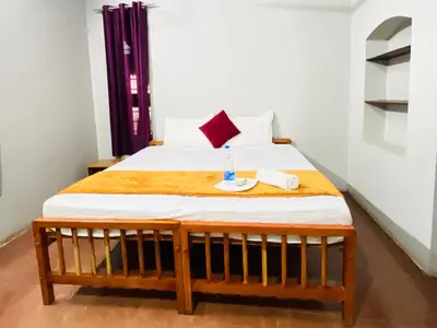 a bedroom with a bed with a bottle of water on it at GoNest O Zen in Kozhikode