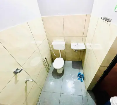 a small bathroom with a toilet and a sink at GoNest O Zen in Kozhikode