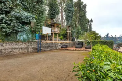 a playground in a park with a fence at Club Mahindra Danish Villa, Ooty in Ooty