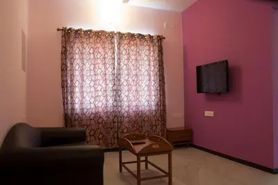 a living room with a couch and a tv at Comfort`s Pearl in Coimbatore