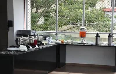 a kitchen with a counter with dishes on it at Heritage Inn in Mysore