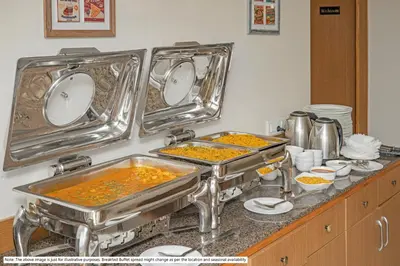 a kitchen counter with two trays of food at Treebo Casino in Kozhikode