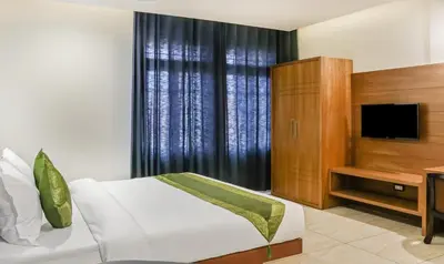 a hotel room with a bed and a television at Treebo Casino in Kozhikode