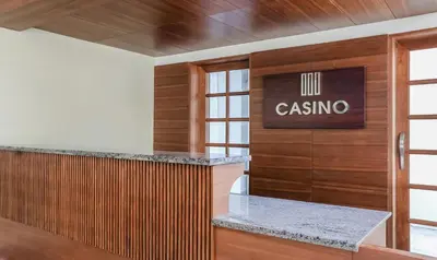 a lobby with a casino sign on the wall at Treebo Casino in Kozhikode